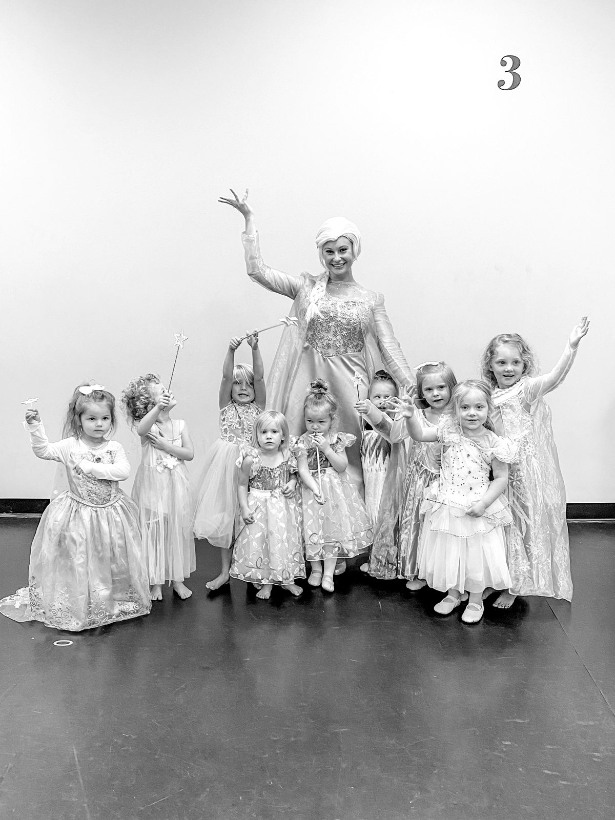 A costumed princess with young dancers in princess dresses in a Centre Pointe studio