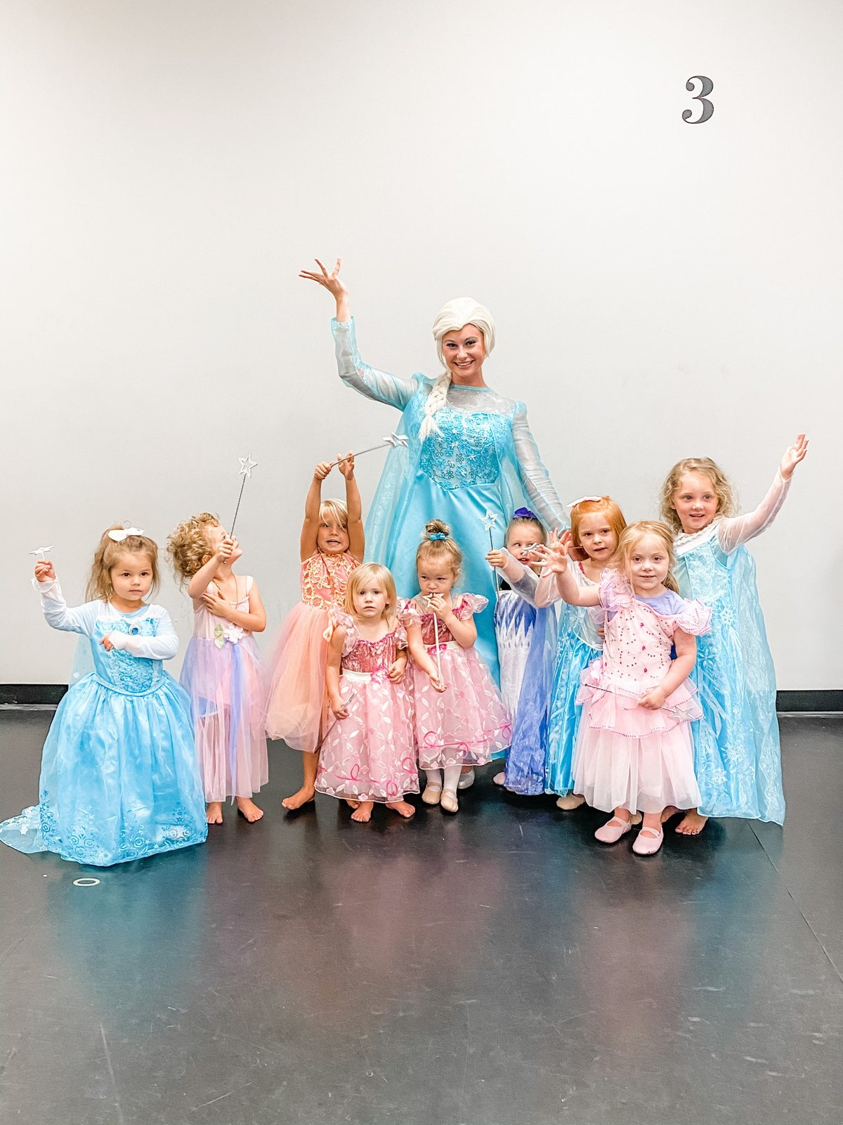 A costumed princess with young dancers in princess dresses in a Centre Pointe studio